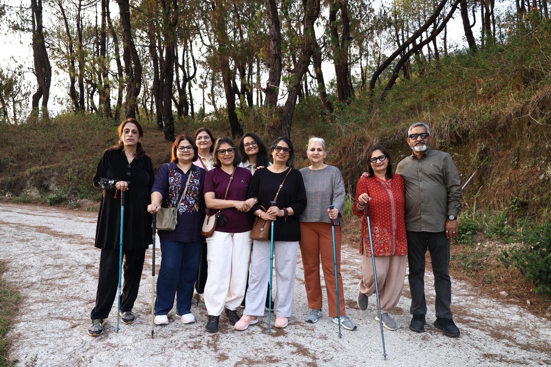 Divine Whisper retreat participants gathered together making heart shapes with their hands